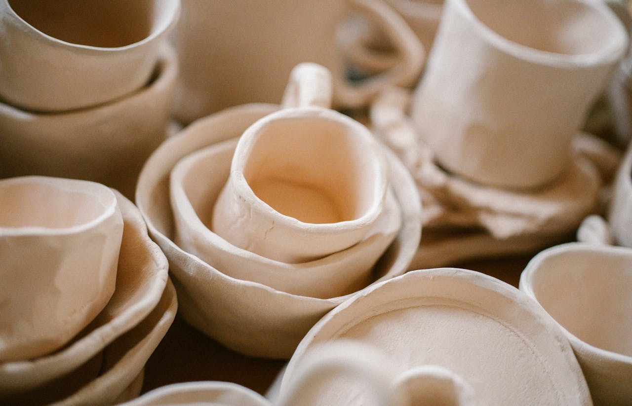 Close-up shot of handmade clay pottery showing unique, artistic shapes.