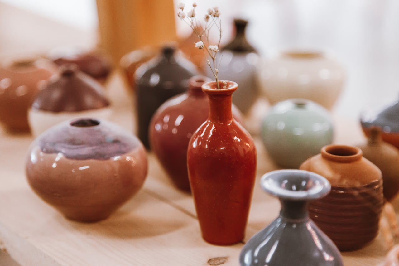 A beautiful display of assorted ceramic vases with varying colors and textures.